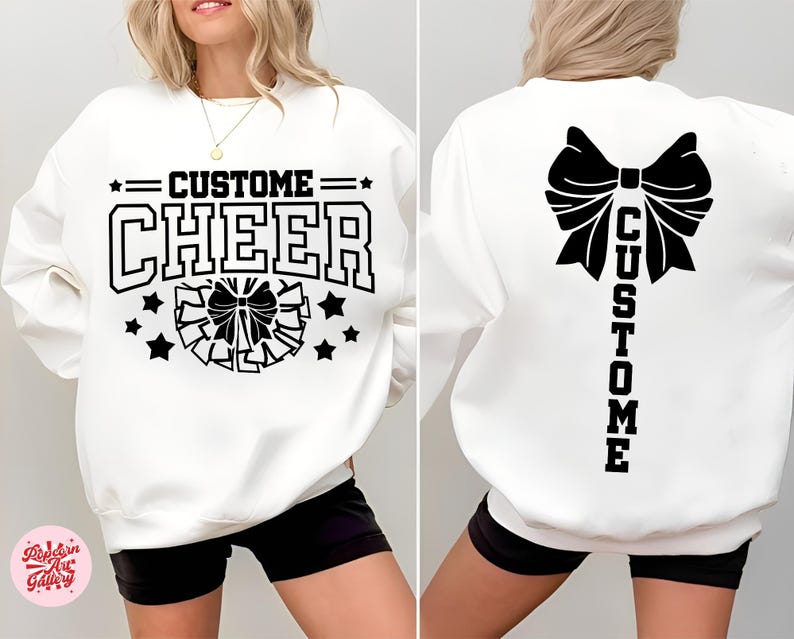 May include: White sweatshirt with the words "CUSTOM CHEER" in black block letters. The front features a cheer bow and stars. The back of the sweatshirt has a large bow and the word "CUSTOM" vertically.