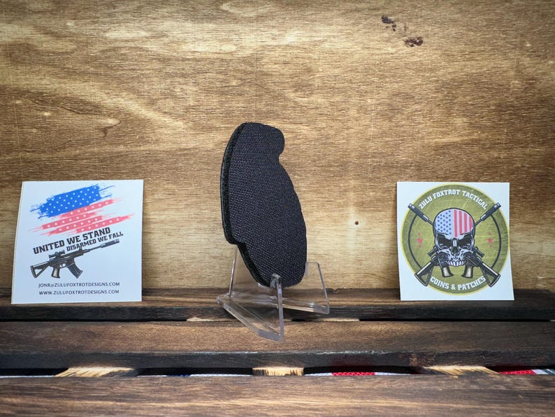 May include: A black patch with a skull and crossbones design. The skull is wearing a red, white, and blue bandana. The text "212th Fox Trot Tactical" is above the skull and the text "Coins & Patches" is below the skull.