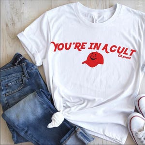You&#39;re In A Cult Kool Aid Red Hat Anti-MAGA shirt, Funny Anti-Trump T-shirt, Progressive activist protest shirt, Unisex Gildan classic tee
