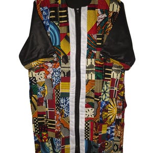 May include: A long-sleeved shirt with a colorful patchwork design. The shirt has a white zipper down the front and black sleeves.