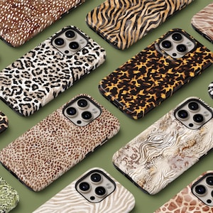 May include: Assortment of phone cases with various animal print designs, including leopard, zebra, and cheetah. The cases are all black and feature a raised camera bump.