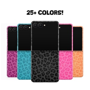 May include: A collection of colorful phone cases, each featuring a unique design. The cases are displayed in a row, showcasing a variety of colors including pink, blue, and orange. The text "25+ COLORS!" is displayed at the top.