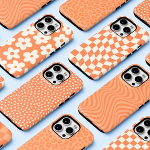 May include: A collection of 10 different phone cases with various abstract patterns in shades of orange and white. The cases are all designed for the iPhone 14 Pro.