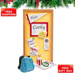 May include: A decorative ornament shaped like a bulletin board with a yellow background and a wooden frame. It features notes that say "Exam Today!" and "Party This Saturday." A blue backpack, pizza, and candy cane are also included.