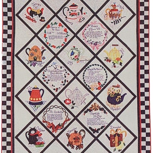 May include: A decorative quilt featuring a grid of diamond-shaped panels, each showcasing a teapot design representing a month. The quilt has a black and white checkered border and a red inner border. The teapots are in various colors and styles.