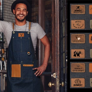 May include: A collection of personalized leather patches with various designs and text. The patches are brown and feature a variety of designs, including a pig, a deer, a bear, a wrench, a coffee cup, a cake, and a chef's hat. The text on the patches includes names, titles, and phrases like "Master Chef", "Cute Cake", "Baked by Kerry", and "Queen of the Kitchen".