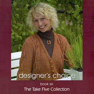 May include: A book cover with the text "elsebeth lavold" at the top. The cover features a woman wearing a brown cardigan. The text "designer's choice" and "The Take Five Collection" are also visible.