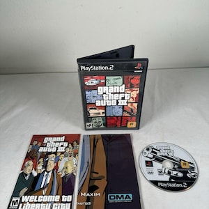 May include: A Grand Theft Auto III video game for PlayStation 2, including the black plastic case with cover art, a Welcome to Liberty City manual, a Maxim promotional insert, and the game disc featuring a black and white handgun graphic.