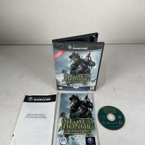 May include: A Nintendo GameCube video game case for Medal of Honor Frontline, including the game disc, instruction booklet, and precautions booklet. The cover art features a soldier in uniform holding a rifle in a battlefield scene.