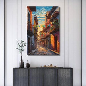 Jalisco Street Wall Art, Colorful Mexico Canvas Print, Papel Picado Decor, Mexican Street Scene, Latin Travel Art, Boho Framed Canvas Gift
Mexican Street Canvas Wall Art, Jalisco Architecture Painting Print, Colorful Framed Canvas, Mexico Wall Decor, Gift for Her, Art Print.Bring golden Mexican streets into your space with this vibrant Jalisco wall art print, glowing with colonial charm