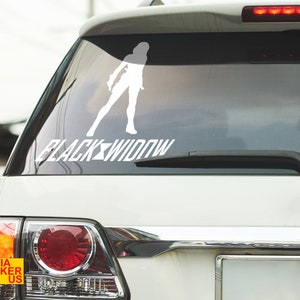 May include: White vinyl sticker of a Black Widow character silhouette with the text "BLACK WIDOW" on a white car window.