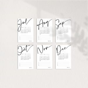 May include: Six printable calendar cards for July, August, September, October, November, and December. Each card features a month name in a handwritten font and a grid of dates for the month.