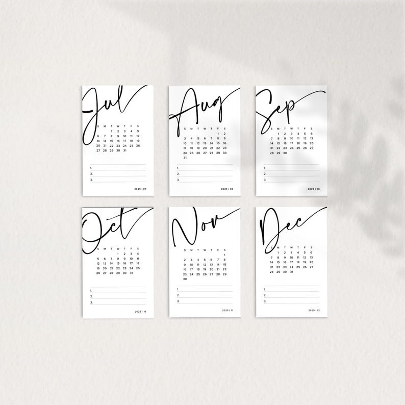 May include: Six printable calendar cards for July, August, September, October, November, and December. Each card features a month name in a handwritten font and a grid of dates for the month.