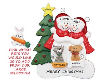 May include: Personalized Christmas ornament featuring a snowman couple, Steve and Kelly, hugging in front of a green Christmas tree. The ornament includes a cat named Patches and a dog named Aspen. The text "Merry Christmas" is written below the snowmen.