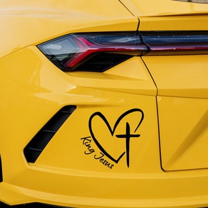 May include: A yellow car with a black heart and cross decal that says "King Jesus".
