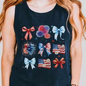May include: A navy blue sleeveless tank top with a red, white, and blue bow and firework design.