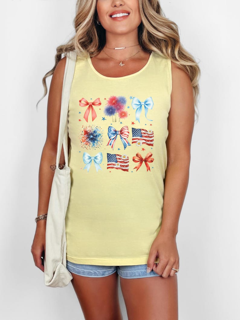 May include: A yellow sleeveless tank top with a graphic print of red, white, and blue bows, fireworks, and American flags.