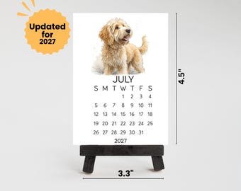 May include: A white calendar card for July 2027 featuring a watercolor illustration of a golden-colored dog. The card measures 4.5 inches in height and 3.3 inches in width. A yellow badge in the top left corner displays the text Updated for 2027.
