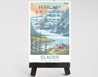 May include: A white ceramic mug with a black handle and the text "But First, Coffee" in a bold, black font. The mug is filled with a dark liquid, likely coffee, and sits on a light-colored surface.