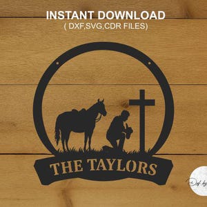 May include: Black silhouette design featuring a horse, a person kneeling before a cross, and the text "THE TAYLORS" within a circular frame. The words "INSTANT DOWNLOAD" and file types are at the top. The design is set against a wood grain background.