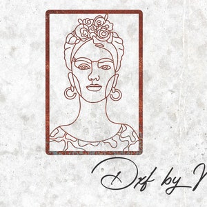 May include: Line art drawing of Frida Kahlo in a frame with a rusty brown border. The drawing is in black and white and features a floral crown, large hoop earrings, and a patterned blouse.