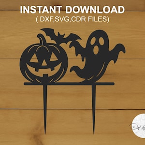May include: Black Halloween-themed cake topper featuring a jack-o'-lantern, a bat, and a ghost. The text "INSTANT DOWNLOAD" is at the top. The design is on a wooden background. The cake topper has two prongs.
