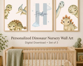 May include: A set of three framed wall art prints featuring watercolor illustrations of various dinosaurs, including a T-Rex, pterodactyl, ankylosaurus, long-neck, and triceratops, with a central print displaying the letter H and the name Hudson.