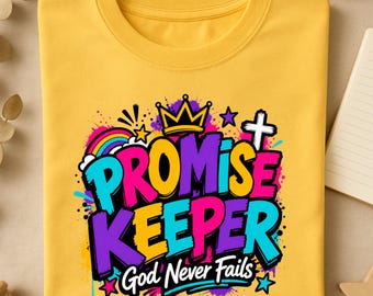 May include: A mustard yellow t-shirt featuring a vibrant graphic print with the text "PROMISE KEEPER" and "God Never Fails" in bold, colorful lettering. The design includes a crown, a rainbow, a cross, and stars with paint splatter accents.