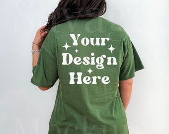 May include: A green t-shirt with the text "Your Design Here" in white on the back.