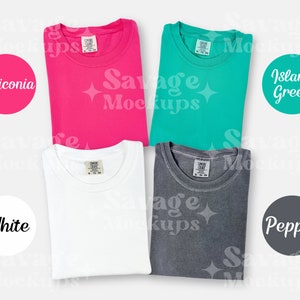May include: Four folded t-shirts in different colors: white, pink, teal, and gray. The shirts are laid out on a white background. The colors are labeled with circles: white, heliconia, island green, and pepper.