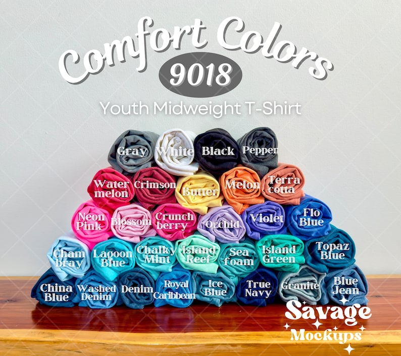 May include: A variety of youth midweight t-shirt colors rolled up and stacked in a pyramid shape. The colors include: gray, white, black, pepper, water melon, crimson, butter, melon, terra cotta, neon pink, blossom, crunch berry, orchid, violet, flo blue, topaz blue, cham ray, lagoon blue, chalky mint, island reef, sea foam, island green, china blue, washed denim, royal caribbean, ice blue, true navy, granite, and blue jean.