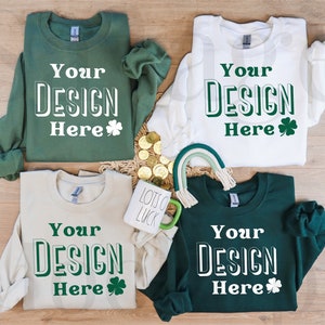 May include: Four long-sleeved sweatshirts in green, white, beige, and dark green with the text "Your Design Here" and a shamrock printed on each.