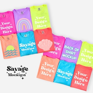 May include: A collection of colorful t-shirts in various shades, including pink, purple, and neon green. Some shirts feature text that says "Your Design Here" and "Savage Mockups". Other shirts have graphic designs like a rainbow, a seashell, and a sun.