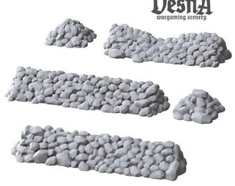 May include: A set of five gray, unpainted resin wargaming scenery pieces featuring two long stone walls, one medium stone wall, and two small stone piles. The text Vesna wargaming scenery is printed in the upper right corner of the image.