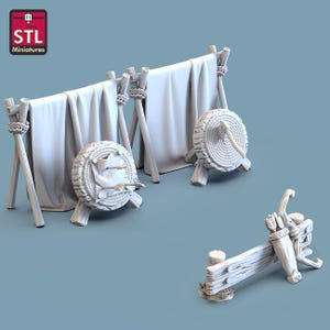May include: A 3D-printed miniature archery set, including a target, bow, and arrows. The set features a white color scheme with a rustic aesthetic. The targets are round, and the bow is resting on a wooden stand. The image includes the text "STL Miniatures".