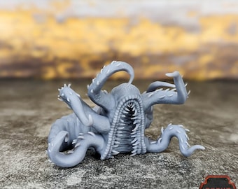 May include: Gray 3D printed miniature of a tentacled creature with a gaping mouth. The creature has a textured surface and is posed in a menacing stance.
