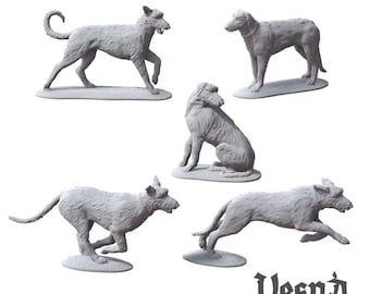 May include: Five unpainted gray miniature dog figurines in various poses, including standing, sitting, and running. Each figure is mounted on an oval base. The text "Vesna wargaming scenery" is printed in black in the bottom right corner.