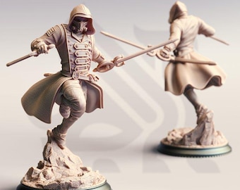 May include: Two beige figurines of a person in a hooded coat, holding swords in a dynamic pose. The figures are mounted on a rocky base with a circular, dark-colored base. One figure is in the foreground, and the other is in the background.