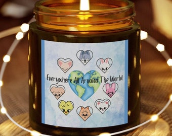 May include: A brown glass candle with a blue and white label. The label features a globe surrounded by hearts with cartoon animals inside. The text on the label reads "Everywhere All Around The World".