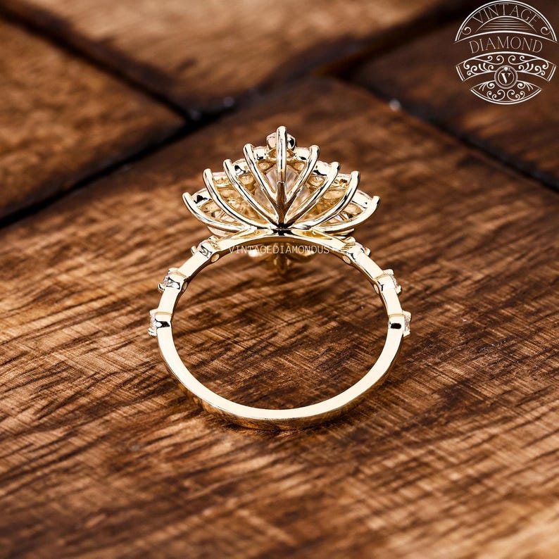 Side-angle view of a handcrafted marquise lab-grown diamond halo ring with alternating round and marquise diamonds forming a shimmering floral halo. With EF color and VVS+ clarity, this engagement ring blends modern craftsmanship with sustainable brilliance.