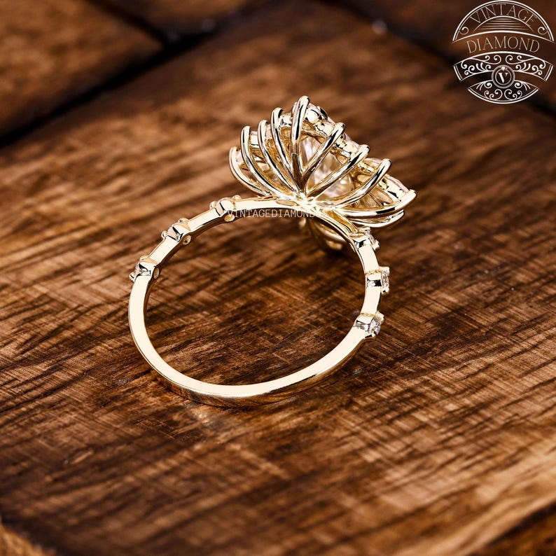 A bright marquise-cut lab-grown diamond engagement ring designed with a stunning floral halo of small diamonds. The handmade setting features premium craftsmanship and high clarity stones, delivering a captivating sparkle perfect for romantic milestones.