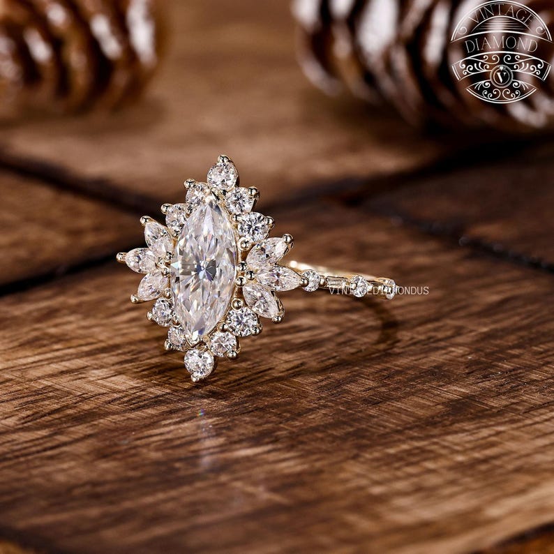 Close-up view of a marquise lab-grown diamond halo engagement ring featuring a floral halo of round and marquise-cut lab diamonds. The central stone displays excellent cut and EF color, offering bright white sparkle. Set in polished gold, this ring combines sustainability, craftsmanship, and luxury for the modern bride.