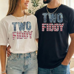 May include: Two people wearing matching t-shirts. One shirt is white, the other is black. Both shirts have the words "TWO FIDDY" in a patriotic design with stars and stripes.
