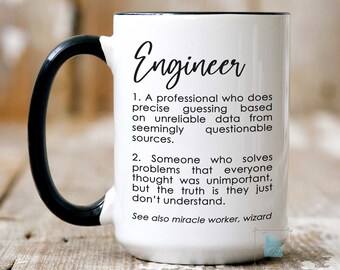May include: White ceramic coffee mug with a black handle. The mug has a black rim and the text "Engineer" in black lettering. The text below the word "Engineer" defines the word as a professional who solves problems that everyone thought were unimportant.