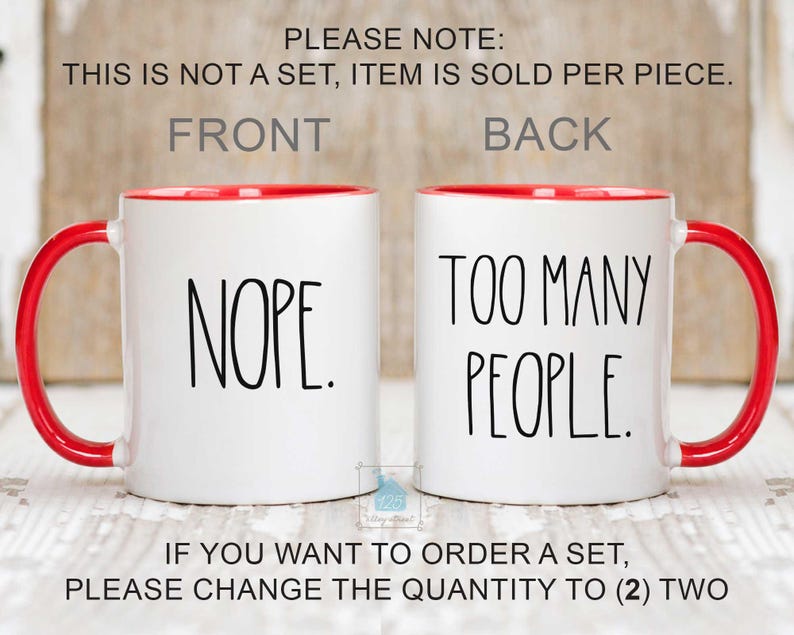 May include: Two white ceramic mugs with red interiors and handles. One mug says "NOPE." in black text, and the other says "TOO MANY PEOPLE." The mugs are displayed side-by-side.