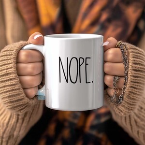 May include: A set of three ceramic mugs with a speckled, matte finish. The mugs are in shades of cream, light gray, and dark gray. Each mug has a simple, minimalist design, perfect for coffee or tea.