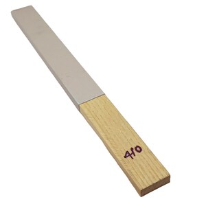 May include: A grey sharpening steel with a wooden handle. The handle is labelled "410".