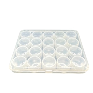 May include: A clear plastic storage box with 20 small round containers. The containers are arranged in a 4x5 grid.