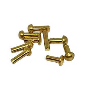 May include: A collection of small, shiny, gold-coloured rivets. Each rivet has a rounded head and a cylindrical post. The rivets are scattered across a white background, with some overlapping.