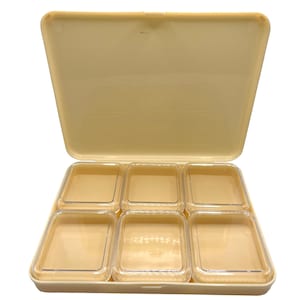 May include: A beige plastic storage box with a hinged lid and six clear compartments. The box is open and the compartments are empty.